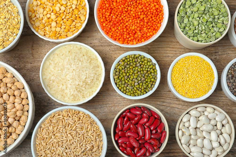Different grains and cereals on wooden table, flat lay Different grains and cereals on wooden table, flat lay