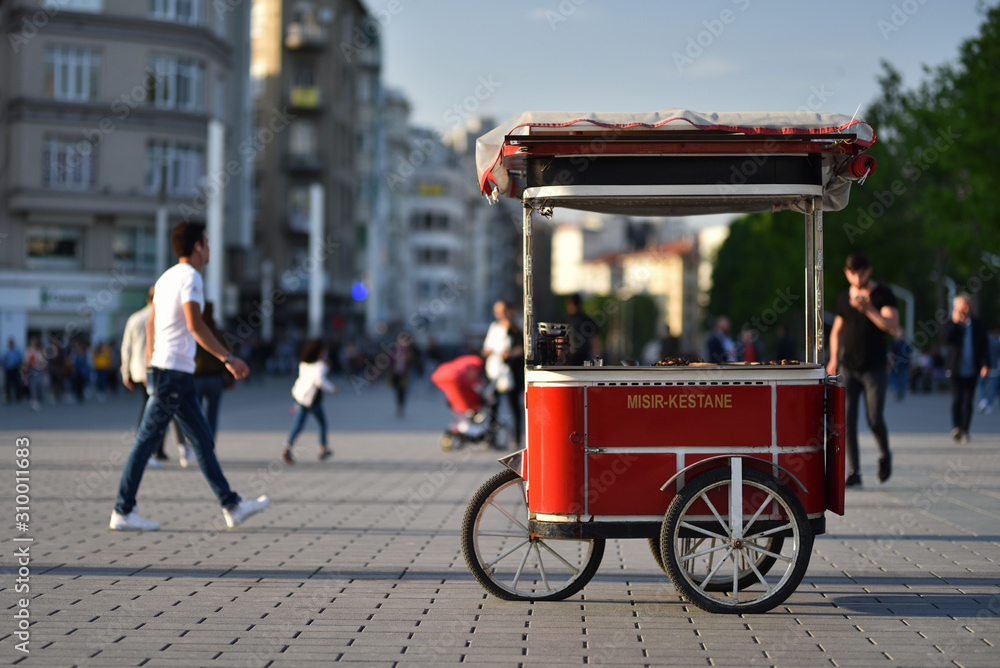 Turkish traditional street food cart on wheels. Text on cart in translating from Turkish language to English is Corn and chestnut.