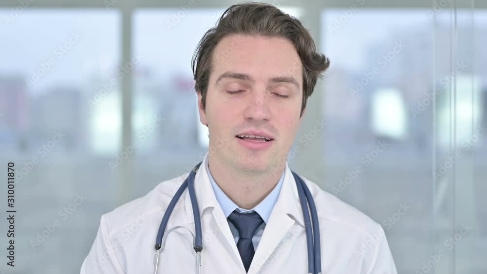 Portrait of Cheerful Young Male Doctor doing Video Chat Portrait of Cheerful Young Male Doctor doing Video Chat