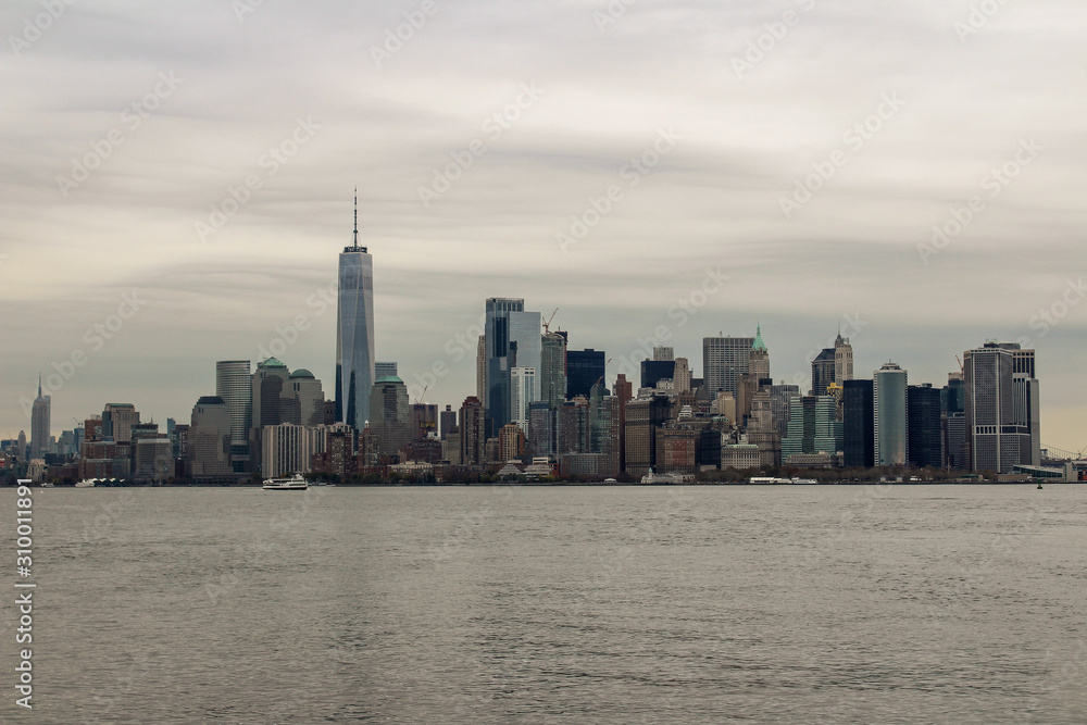 Manhatten, New York City skyline with Hudson river and grey skies