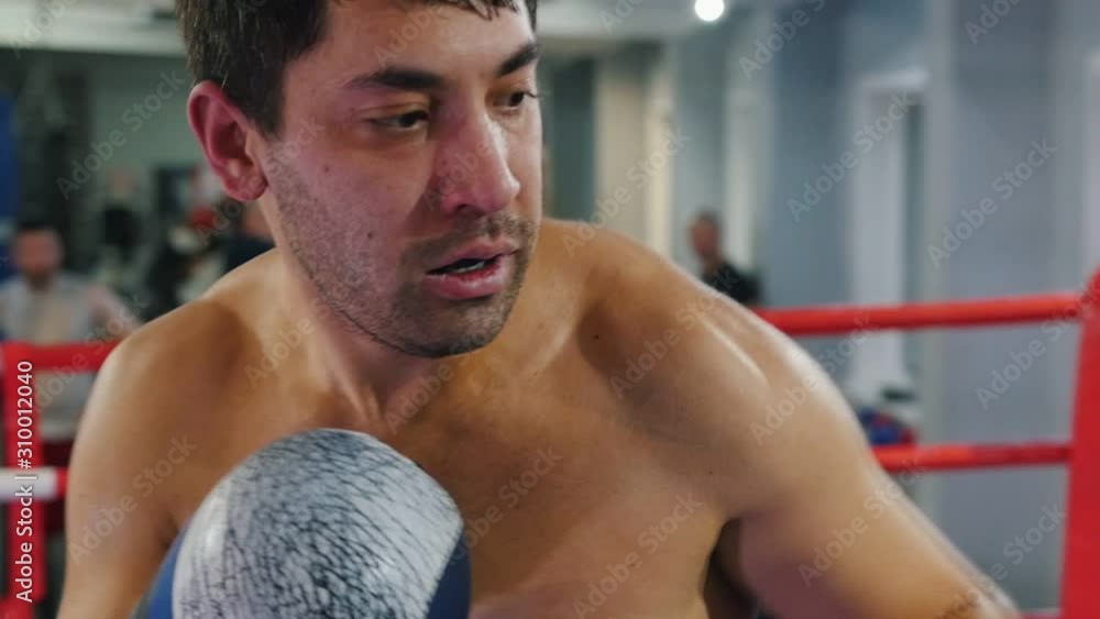 Boxing - two sweaty men having an aggressive fight in the gym Boxing - two sweaty men having an aggressive fight in the gym
