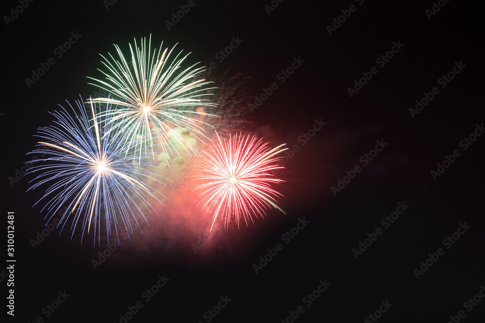 Abstract colored firework background in the night sky