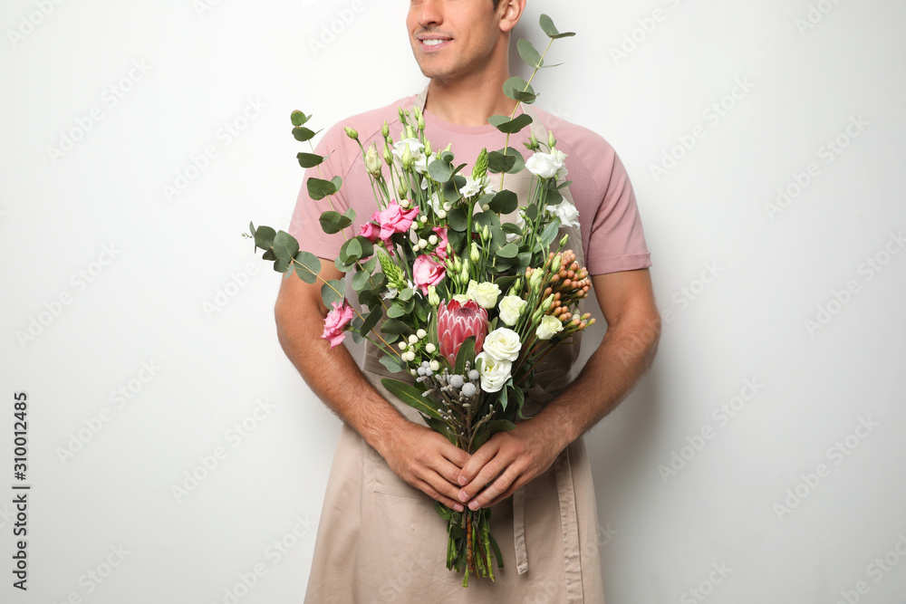 Florist with beautiful bouquet on light background, closeup Florist with beautiful bouquet on light background, closeup