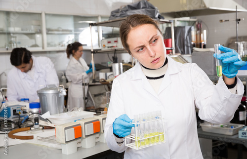 Female student examining chemical substances
