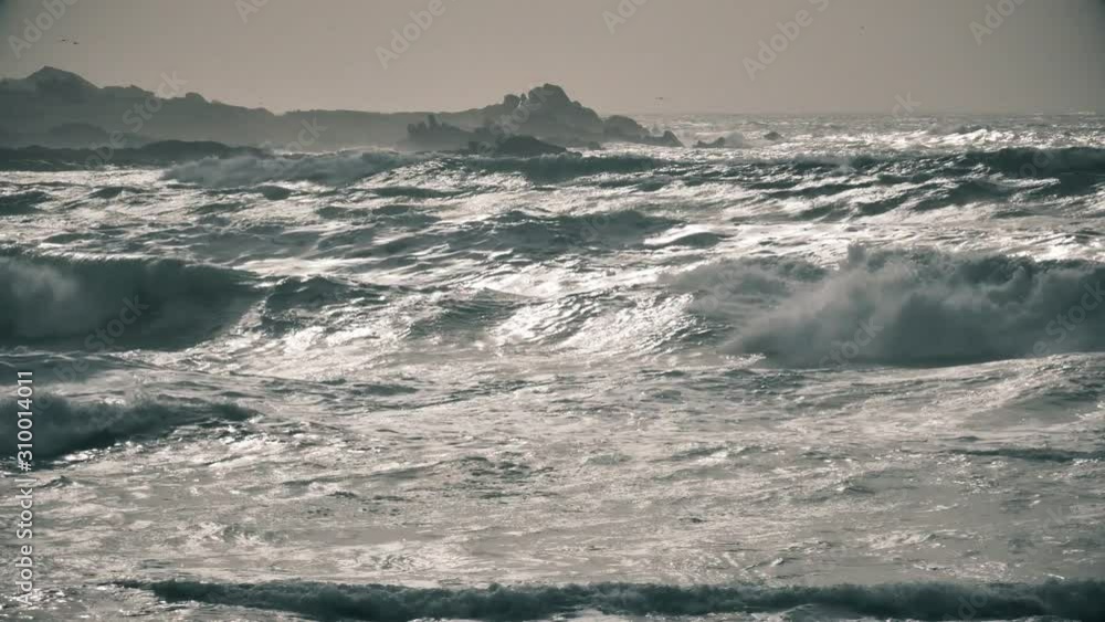Waves breaking on evil rocks and roll on beach, amazing silver light Waves breaking on evil rocks and roll on beach, amazing silver light