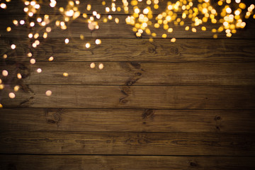 Golden lights on wooden background
