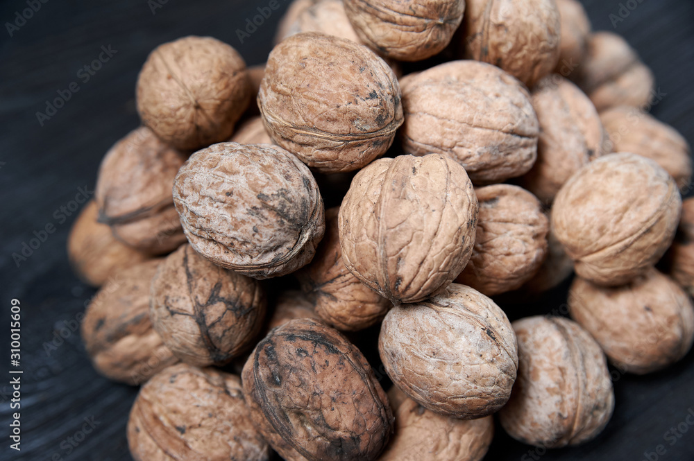 walnut on a black wooden background still life, walnut walnut on a black wooden background still life, walnut