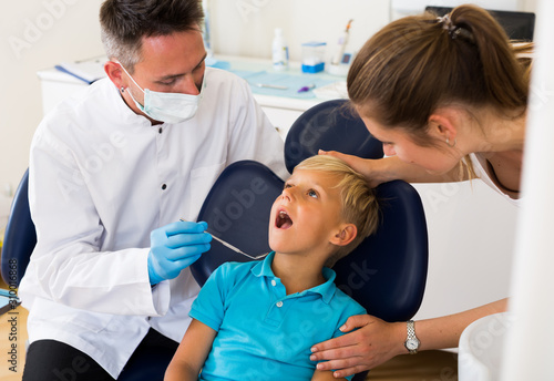 Kid with woman are visiting dentist