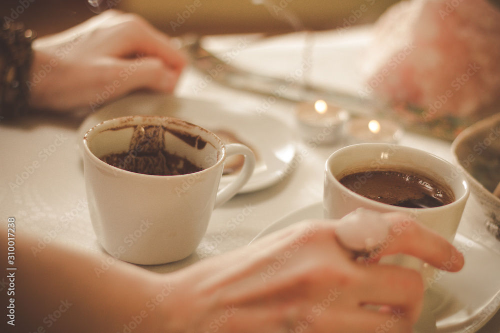 Coffee ground fortune teller, holding cup of coffee, close up Coffee ground fortune teller, holding cup of coffee, close up