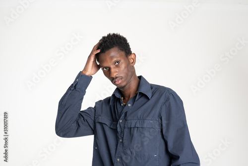 A black guy (man) in a blue shirt and jeans