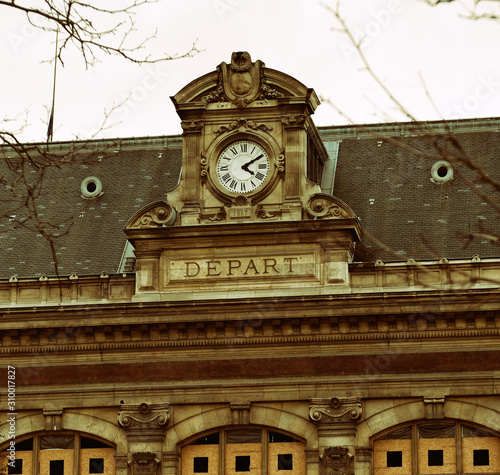 Facade of Haussmannian style building from 1867 with clock and 