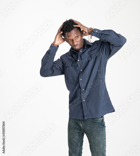 A black guy (man) in a blue shirt and jeans