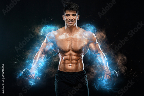 Athlete bodybuilder. Strong muscular man pumping up muscles with dumbbells on black background. Workout bodybuilding concept. Copy space for sport nutrition ads.