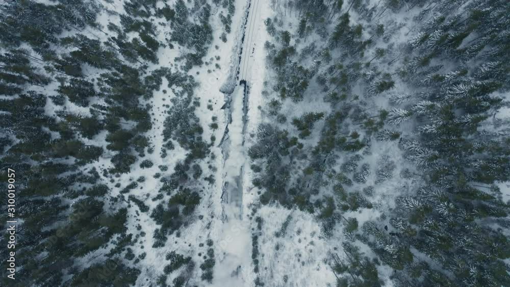 Aerial top view old steam train running in winter snowy forest. Top down view Heritage historic steam locomotive Aerial top view old steam train running in winter snowy forest. Top down view Heritage historic steam locomotive