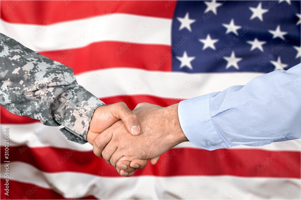 Business Agreement Handshake military hand and businessman on background
