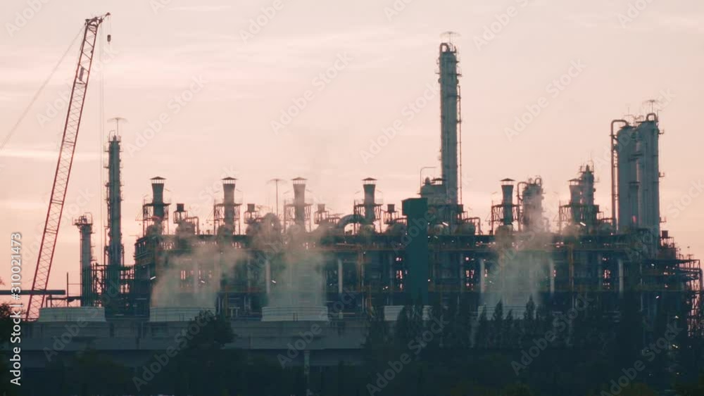 Oil refinery factory Billowing steam from smoke stack falling sky,Refinery oil and gas industrial plant. Oil refinery factory Billowing steam from smoke stack falling sky,Refinery oil and gas industrial plant.