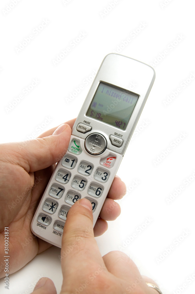 Man Dialing a Wireless Home Phone on White Background Man Dialing a Wireless Home Phone on White Background