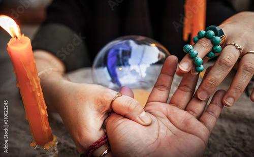 Fortune telling casts a spell, witchcraft with Magic crystal ball in Ceremony . Concept of Astrology, Horoscope and alchemy , Maya magic , superstition , predictions and  mysterious mystical . photo