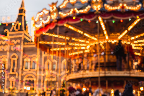 Blurred photo of Christmas carousel at the fair near GUM shop on Red Square in Moscow