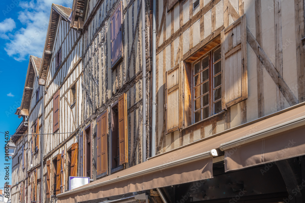 Troyes, France - 09 08 2019: Typical street with half-timbered facades and wooden shutters