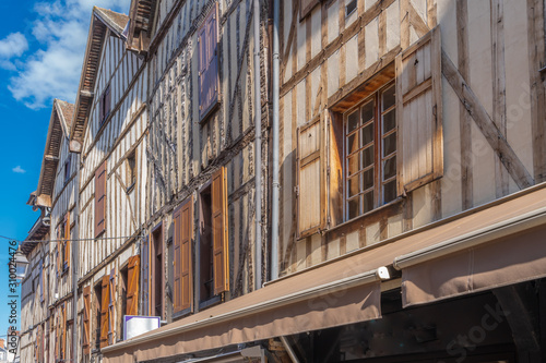 Troyes, France - 09 08 2019: Typical street with half-timbered facades and wooden shutters