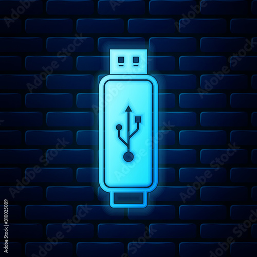 Glowing neon USB flash drive icon isolated on brick wall background. Vector Illustration