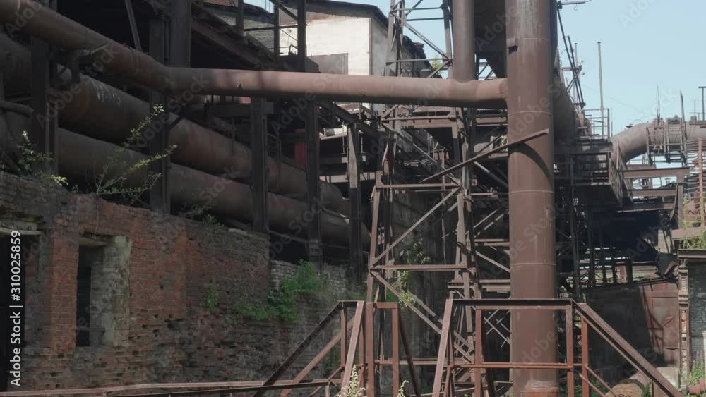 Old rusted metal constructions of the abandoned metallurgic plant. Old rusted metal constructions of the abandoned metallurgic plant.