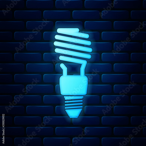Glowing neon Energy saving light bulb icon isolated on brick wall background. Vector Illustration