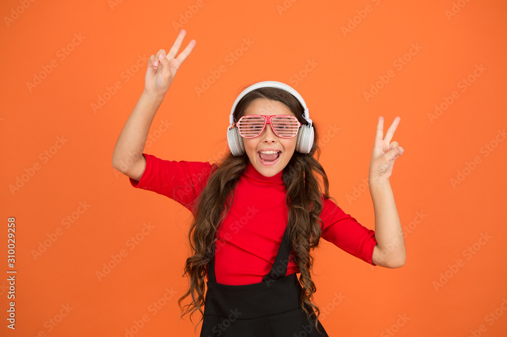 Old school music concept. time for having fun. modern kid enjoy music. feeling stylish and confident. school radio dj. small happy girl listen music in headphones. funny child in party glasses Old school music concept. time for having fun. modern kid enjoy music. feeling stylish and confident. school radio dj. small happy girl listen music in headphones. funny child in party glasses