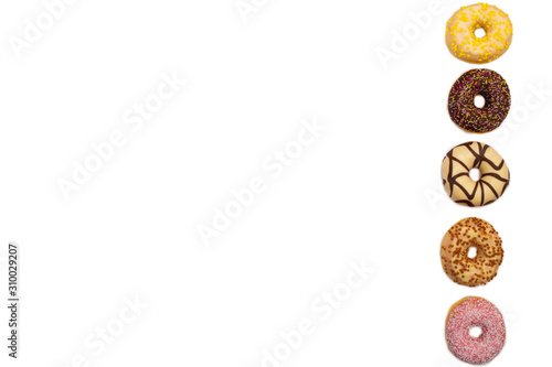 various colored delicious donuts on white background, space for text © annebel146