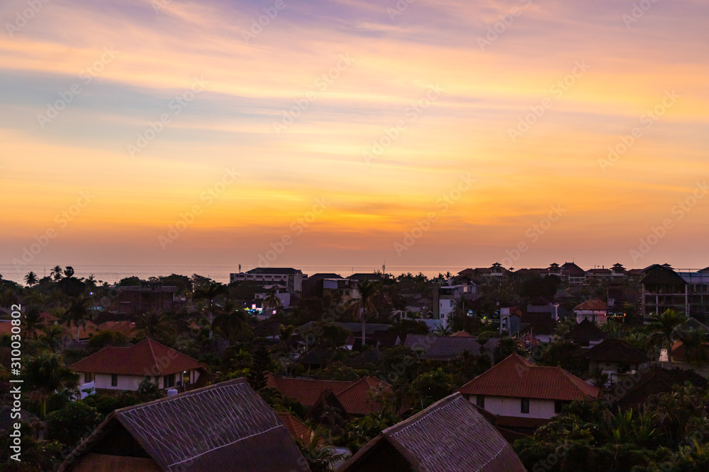 Sunset over Seminyak district with colorful landscape background. Bali island, Indonesia.