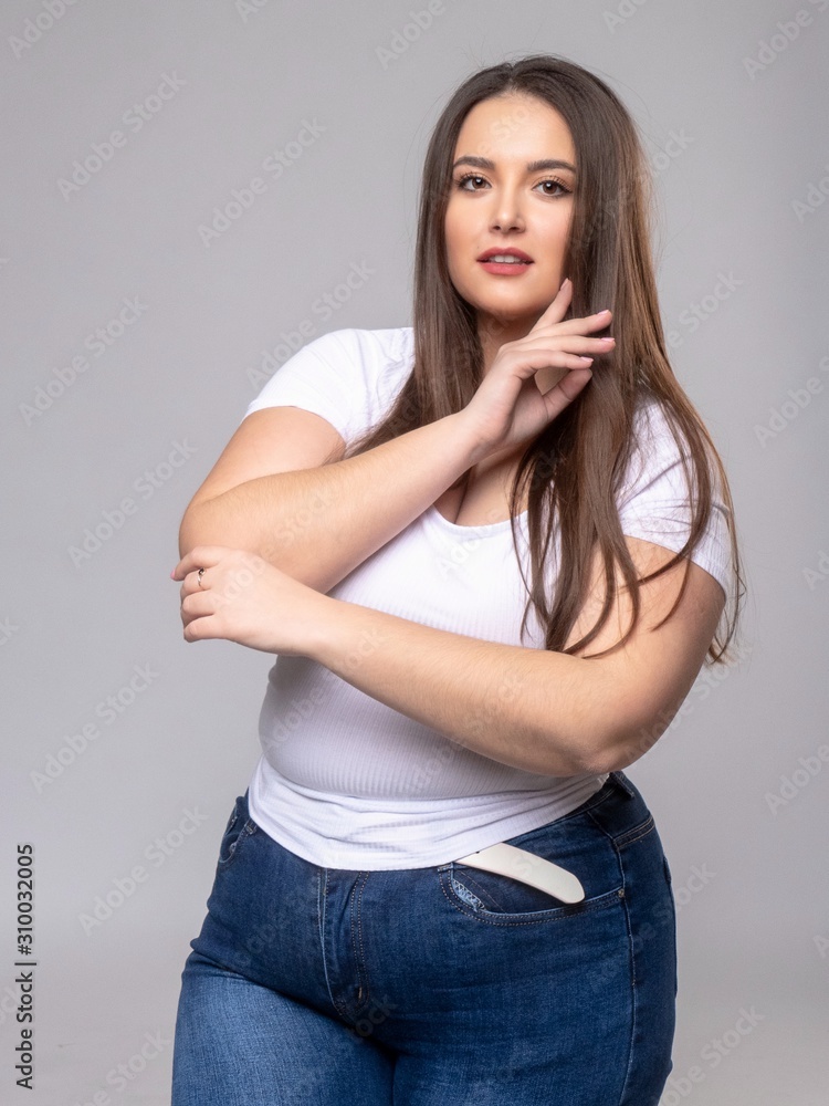 Plus Size Model with long hair posing in studio Plus Size Model with long hair posing in studio