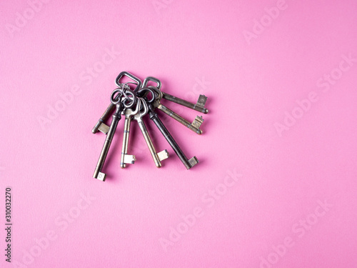 bunch of keys isolated on pink background