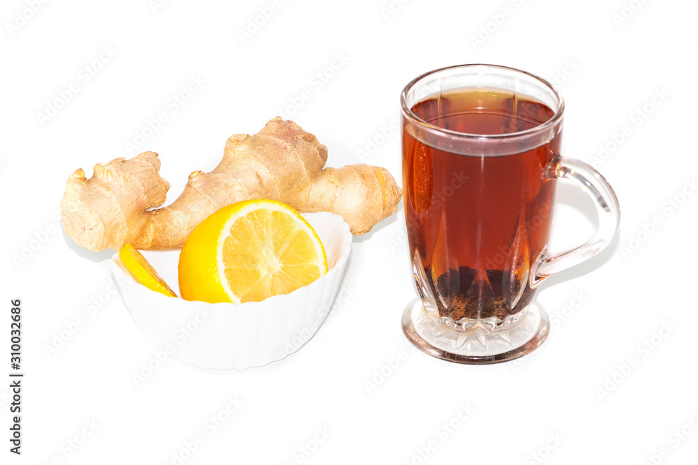 Hot tea with lemon and ginger in transparent glass isolated on white background.