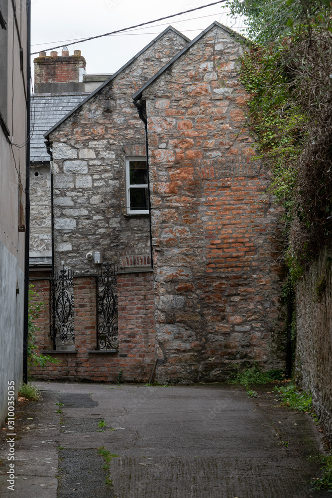 View of empty alley amidst old Victorian buildings, City of Cork, County Cork, Ireland View of empty alley amidst old Victorian buildings, City of Cork, County Cork, Ireland