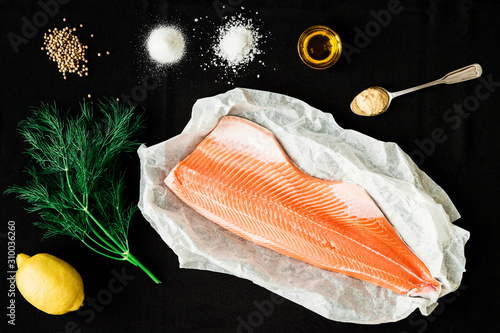 Ingredients for baked salmon on black background photo