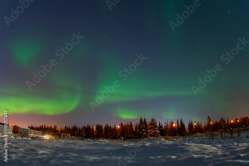 Aurora borealis in night northern sky. Ionization of air particles in the upper atmosphere. photo
