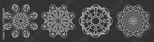 Set of four abstract circular ornaments. Decorative patterns isolated on black background.