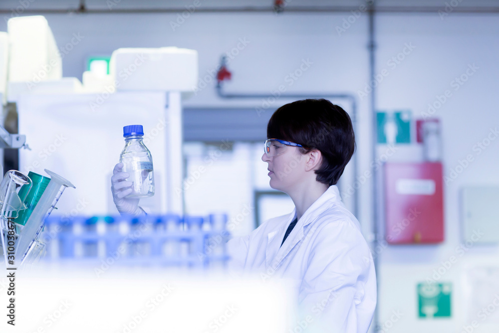 Female laboratory technician working in a laboratory Female laboratory technician working in a laboratory