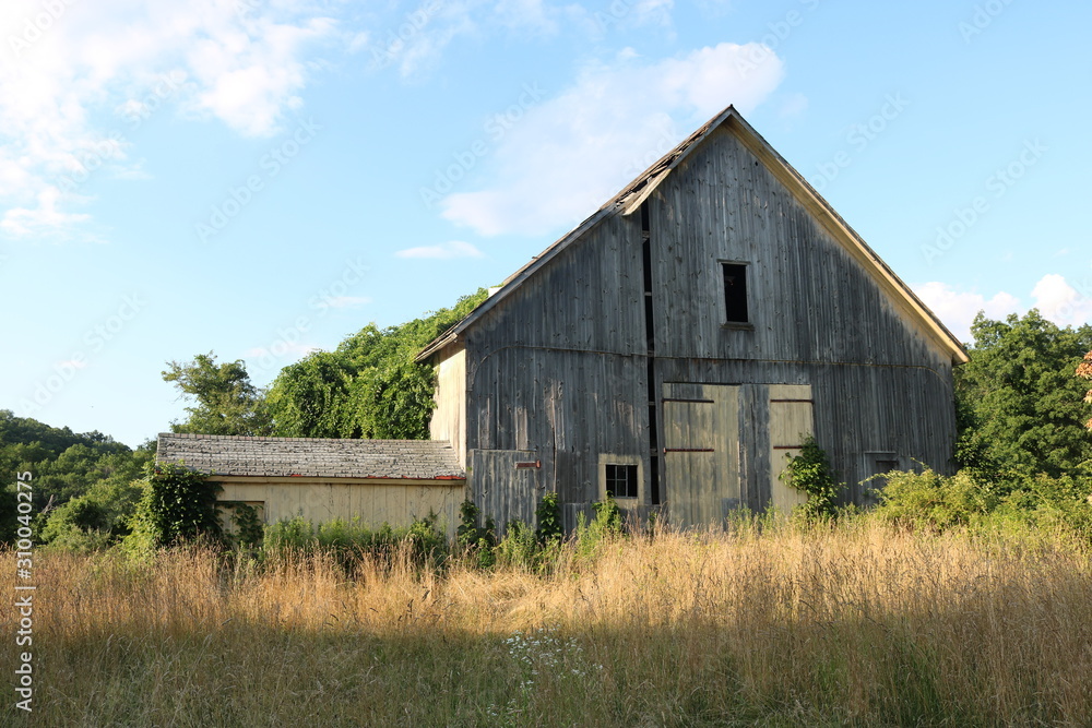 Old abandoned historic farmhouse with broken windows and peeling paint Old abandoned historic farmhouse with broken windows and peeling paint