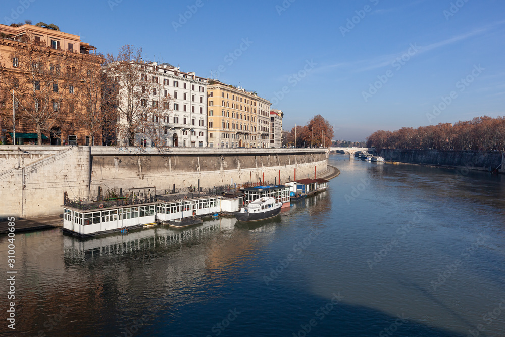 Embankment of the Tiber River in historic center of Rome in sunny winter day, Italy
