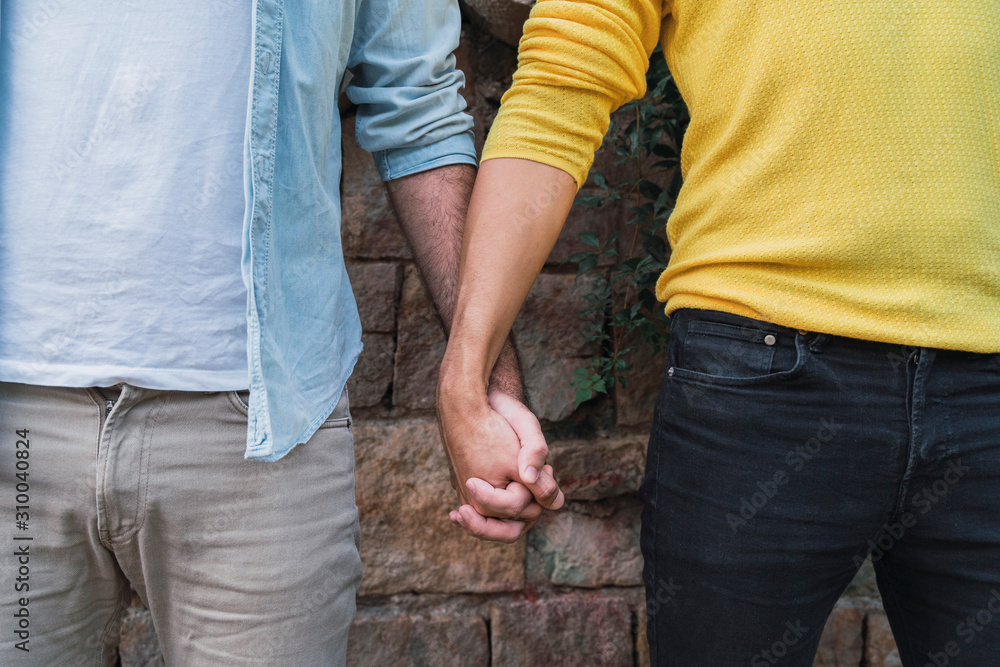 Crop view of gay couple hand in hand Crop view of gay couple hand in hand