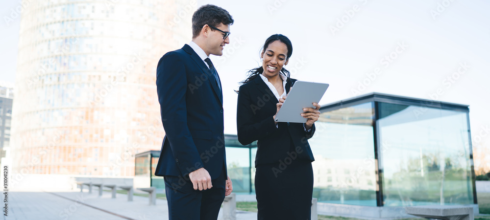 Fototapeta premium Professional coworkers sharing tablet and talking