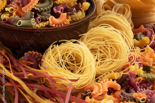 Different types of pasta with brown bowl.