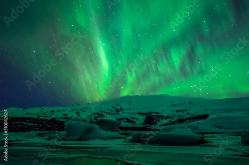 Aurora borealis in night northern sky. Ionization of air particles in the upper atmosphere. © Ludmila