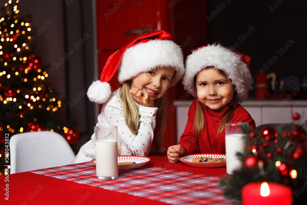 Cute little children at table in dining room. Christmas time Cute little children at table in dining room. Christmas time
