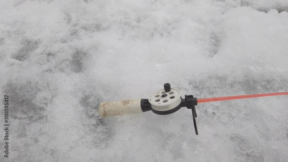 Fishing rod for winter fishing near the ice hole. Winter fishing Fishing rod for winter fishing near the ice hole. Winter fishing