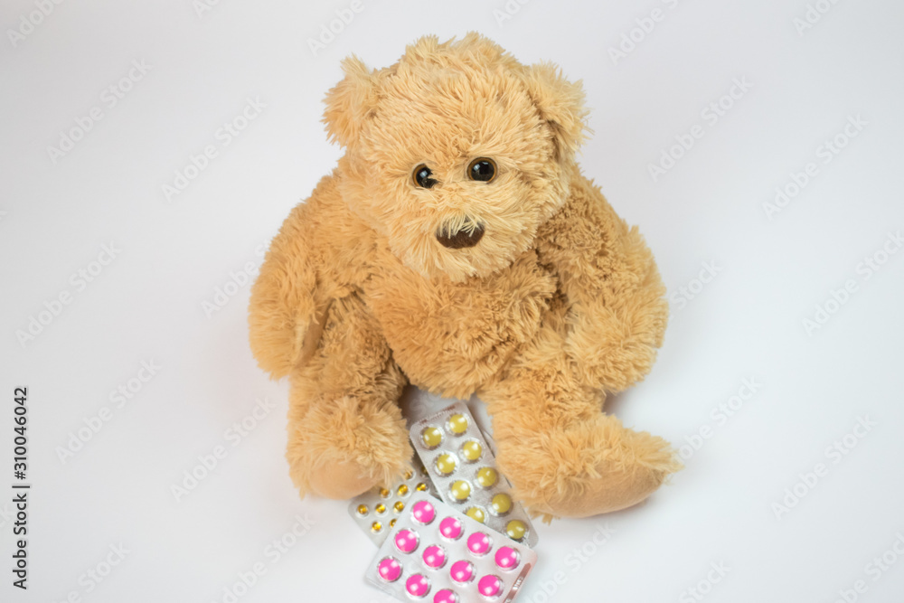 Obraz premium sick kids bear sit on floor closeup pills health save doctor