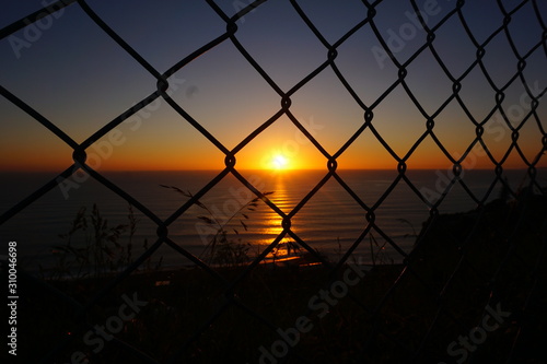 Sunset through a fence