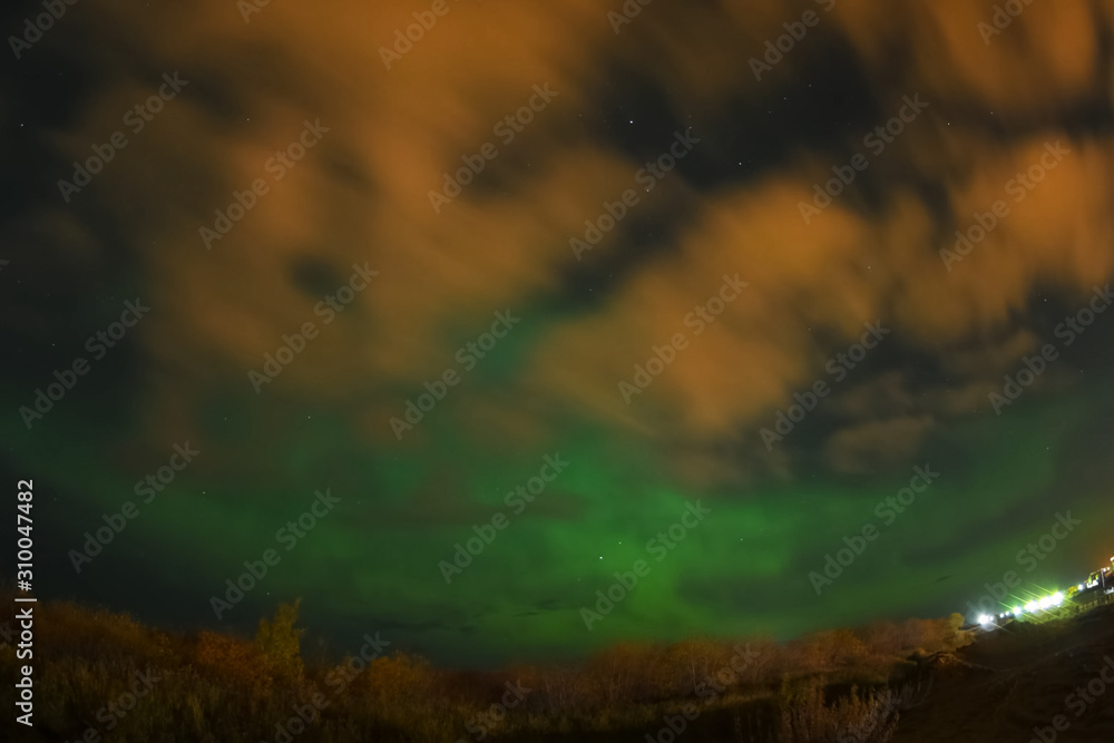 Fototapeta premium Aurora borealis in night northern sky. Ionization of air particles in the upper atmosphere.